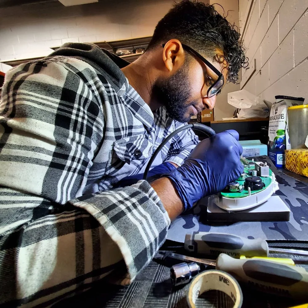 JR Auto Workz technician working on a vehicle component